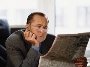 Businessman Reading Newspaper Financial Page